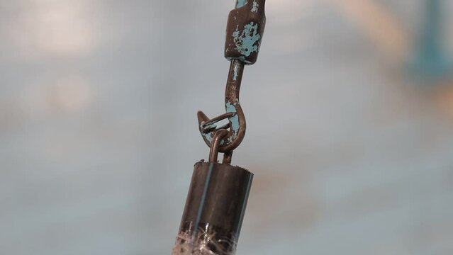 old rusty metal hook - mount. old rusty hook close-up on a blurred background. rusty metal hook. old rusty metal carbine on a blurred background