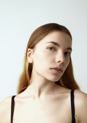 portrait of a beautiful woman with well-groomed skin on a light background