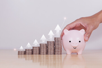 Piggy bank and coins stack with white up arrow. Concept for invest and saving success in the future...
