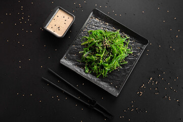 Wakame seaweed salad with sesame seed. Traditional Japanese food. Top view. © Volodymyr