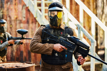 Portrait, paintball or man with gun in a game or competition for fitness, exercise or cardio...