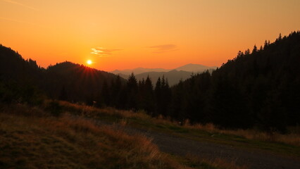 Naklejka na ściany i meble Sunrise in the mountains of the national park. 