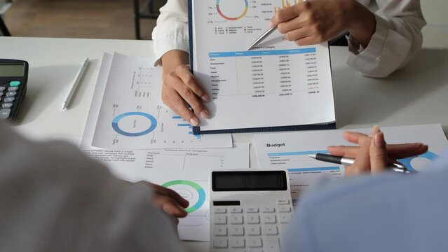 Meeting business people brainstorm to analyze charts in business finance report, financial and investment account planning. Discuss the analysis of the market growth situation and the company's sales.