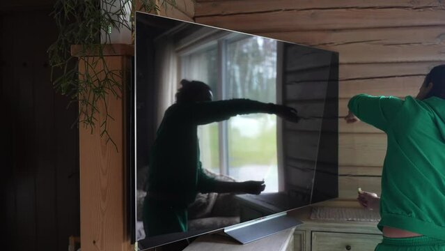 Slow Motion Camera Shot Of Woman Removing The Protective Plastic Film From Brand New Tv Screen Applied In The Factory.