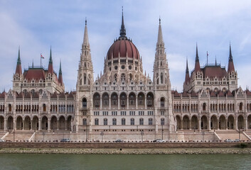 Fototapeta na wymiar Budapest, Hungary - 15.05.2015: Wide frontal horizontal shot of Budapest parliament, Orszaghaz, from Danube river.