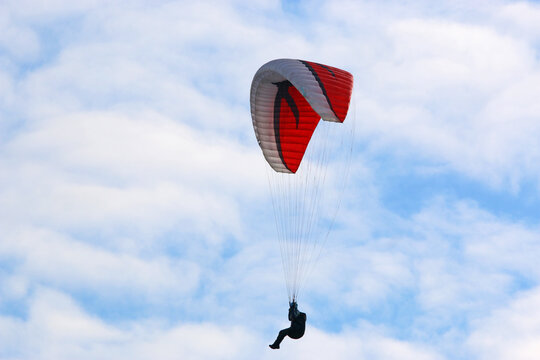 Paraglider flying in a blue sky	
