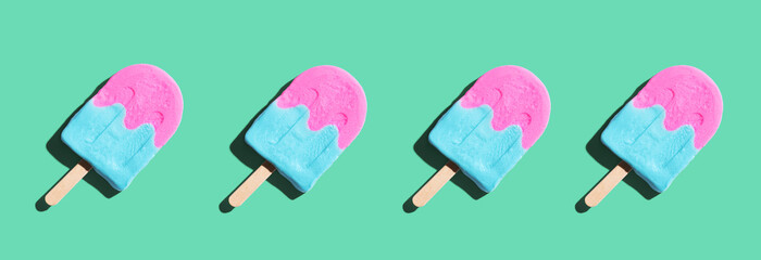 Pink and blue popsicles with shadow - flat lay