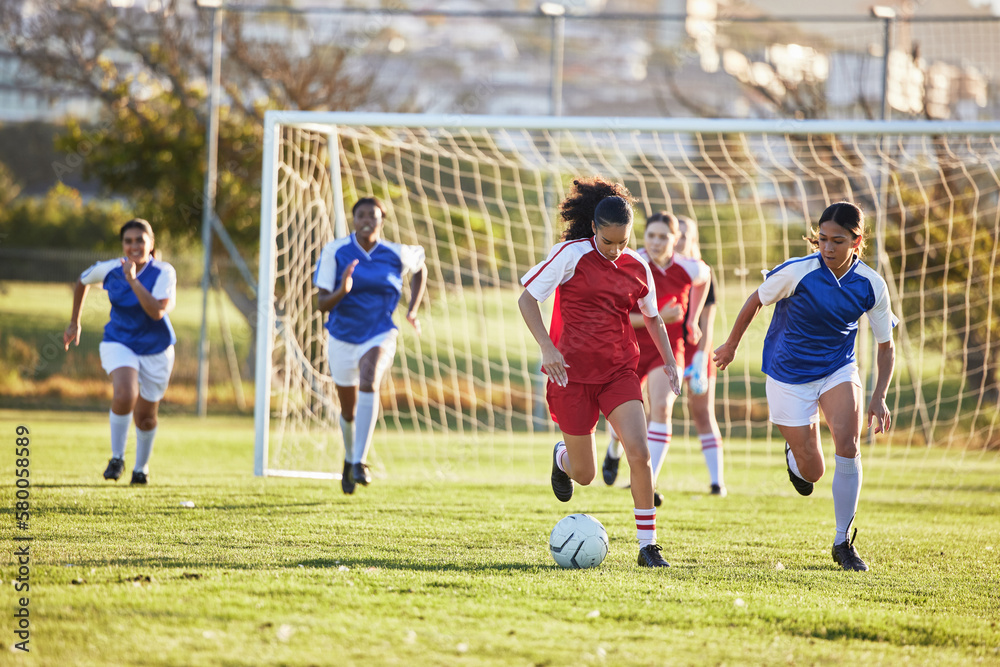 Wall mural Sports team, girl soccer and kick ball on field in a tournament. Football, competition and athletic female teen group play game on grass. Fit adolescents compete to win match at school championship.