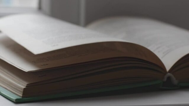 Open book on windowsill or table close up