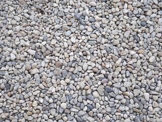 Small boulders on road or decorate your home garden. Pebbles of different shapes, sizes, and colors. Outdoor background design
