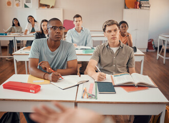 High school, students and boys listening in classroom of education, learning or knowledge. Highschool, studying and attention to teacher, academic lecture and teaching group for young people together