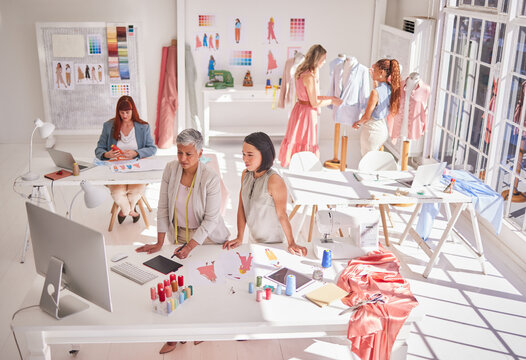 Clothes production, designer and women working on fashion, fabric and textile planning work. Creative studio busy with idea, style innovation and creativity design with collaboration and teamwork
