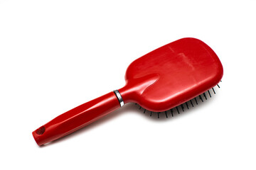 old comb of red color on a white background