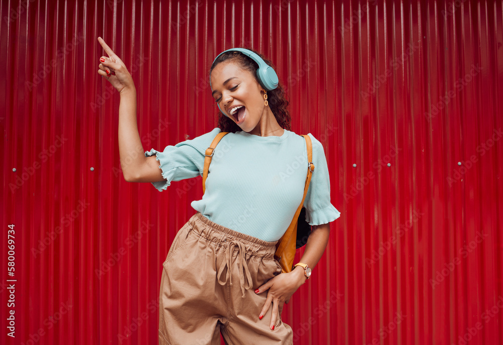 Canvas Prints Music, dance and woman in the city against a red background during a travel holiday in Amsterdam in summer. Happy, smile and girl with freedom, 5g radio and singing with headphones on vacation