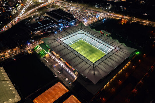 Aerial night view of the illuminated Polish Army Stadium (Stadion Wojska Polskiego), home arena for Legia Warszawa football club. Warsaw, Poland - March 2023
