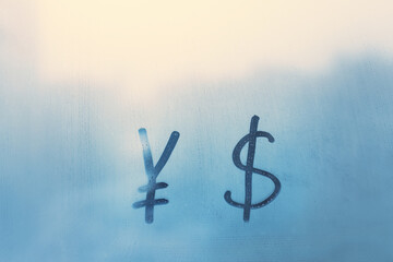 Handwritten doodling sign yuan, american dollar icon on blue foggy glass window