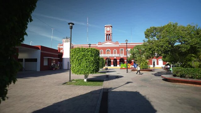 Motul, Yucatan, Mexico - 01 21 2023: Push in to the Municipal Palace from the central park.