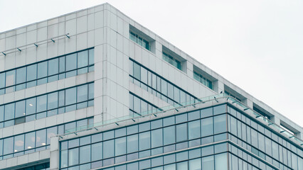 Fototapeta na wymiar Skyscraper glass facade. Office exterior. Details of complex high rise building. Financial district. Glass facade building Tech industry