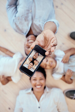 Top view, family and phone selfie in home for happy memory together on floor. Love, care and 5g mobile picture of happy mother, father and children bonding for social media, internet or online post.