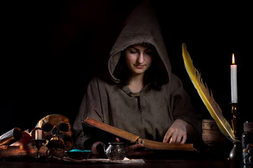 Attractive young woman studying alchemy in the Middle Ages