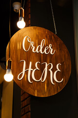 Restaurant service sign Order Here in modern loft style. Can be used in coffee shops, cafes, fast food restaurants.