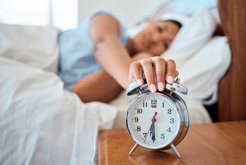 Alarm clock, bedroom and woman stop time to wake up from early morning sleeping at home, house and...