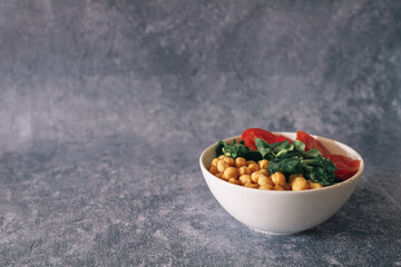 veggie poke filled with chickpeas, arugula and tomato, copy space