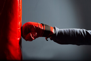A red glove and a red punching bag