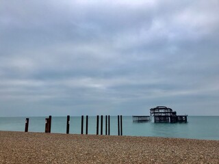 Brighton Beach and Brighton Pier, January 2019. Stony berachj and grey skies. 