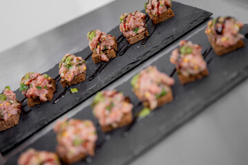 Chef cooks of French restaurant prepares steak tartare from fresh meat