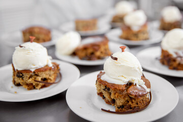 Chef cooks of French restaurant prepares sweet dessert with chocolate and raisins with ice cream