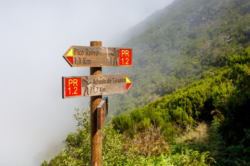 Wooden road destination sign near Pico Ruivo at the highest walking tourist path of Madeira island.