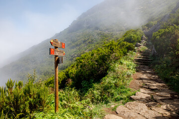 Wooden road destination sign near Pico Ruivo at the highest walking tourist path of Madeira island.