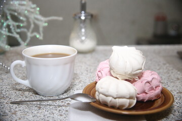 cup of coffee and sweet pink and white marshmllow