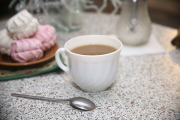 Close up cup of coffee and sweet marshmallow dessert
