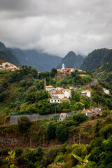 Obraz premium Mountain village among the green island landscape of Madeira.