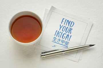 find your ikigai - inspirational handwriting on a napkin with tea, Japanese concept of a life...