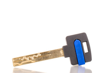 One metal door lock key, macro, isolated on white background.