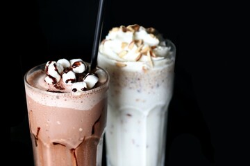 sweet milk shake frappe with topping cream, chocolate sauce, almond, hazelnut, marshmallow yummy , menu chocolate brown milk and white milk