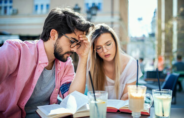 Campus life. Concerned students are learning in the cafe and preparing for the test. Education, relationships, love concept