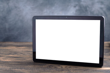 Modern black tablet pc with blank white screen on table. Mockup for video translation