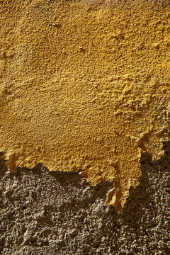 Bright ochre antique plaster with eye-catching partial damage