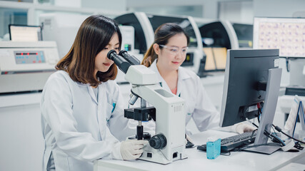 Team of medical research scientists collectively working on new research knowledge of sciences with...