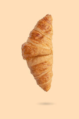 Golden brown butter croissant with shadow isolated on the white background.