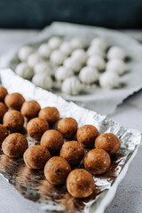 Delicious homemade white chocolate and brown caramel truffles with almonds and nuts in a retro grunge style.