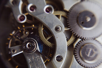 Fototapeta na wymiar macro shot of details of an old Swiss watch, small gears, springs and clock mechanism close-up