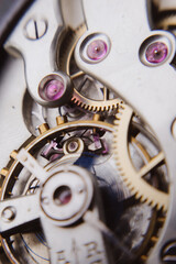 macro shot of details of an old Swiss watch, small gears, springs and clock mechanism close-up