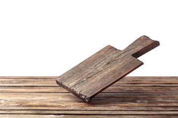 Cutting board falling on an old wooden table.