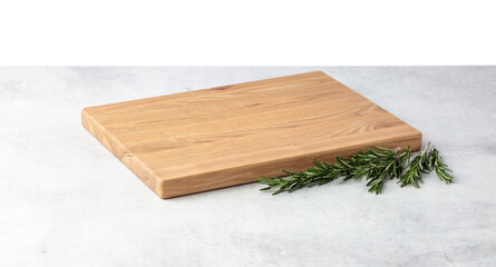 Cutting board and rosemary on a grey stone table.