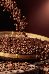 Medium-roasted coffee beans are poured into a basket.